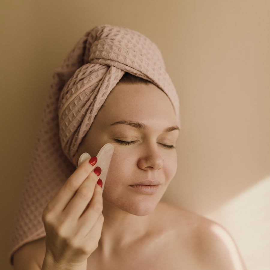 gua sha tool on cheek